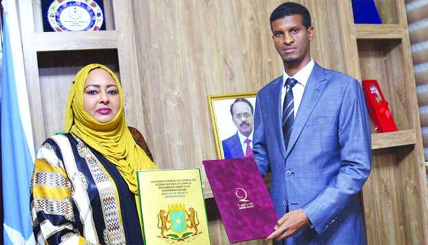 Somalia's Minister of Energy and Water Resources Fawzia Mohamed Sheikh, and Director of Qatar Charity's office in Somalia Abdulnour Haj Ali after signing the agreement.