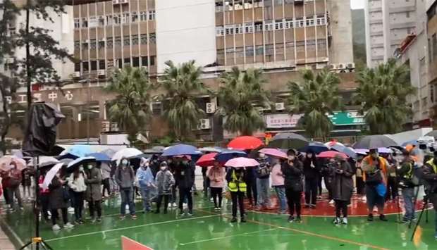 About 100 people braved rain in the New Territories district of Fo Tan, where authorities plan to use a newly built residential development that was subsidized by the government as a quarantine centre
