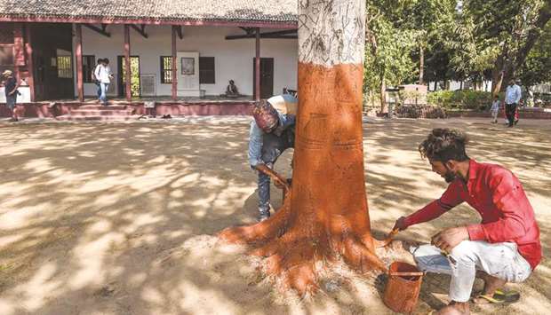 Labourers give finishing touches to a tree in front of the u2018Hriday Kunju2019, the house where Mahatma Gandhi stayed between 1918 and 1930, at Sabarmati Ashram also known as Gandhi Ashram in Ahmedabad yesterday.