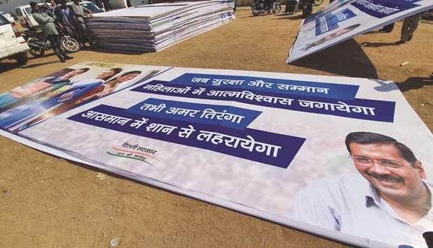 Workers prepare posters ahead of the swearing-in ceremony of AAP leader Arvind Kejriwal at Delhiu2019s Ramlila Maidan ground yesterday.