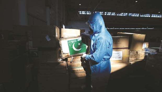 This picture taken earlier this month shows a staffer at a warehouse in Wuhan with medical supplies from Pakistan.