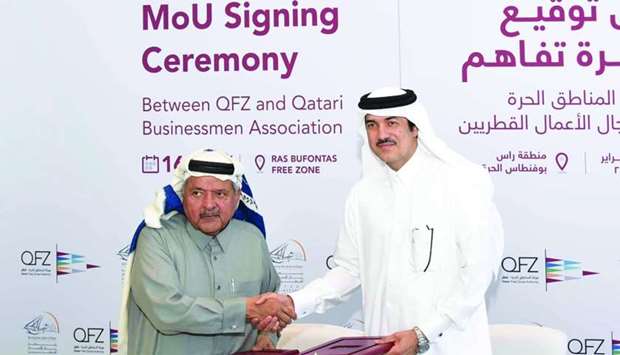 Sheikh Faisal and al-Sayed shaking hands after signing the MoU.rnrn