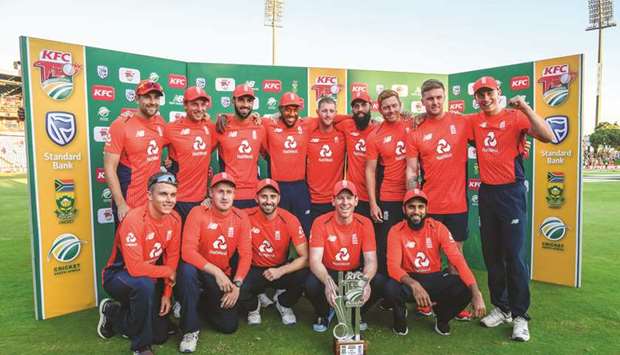 Englandu2019s captain Eoin Morgan (centre) and teammates pose with the series winnersu2019 trophy after the third T20 International match against South Africa at SuperSport Stadium in Pretoria, South Africa, yesterday. (AFP)