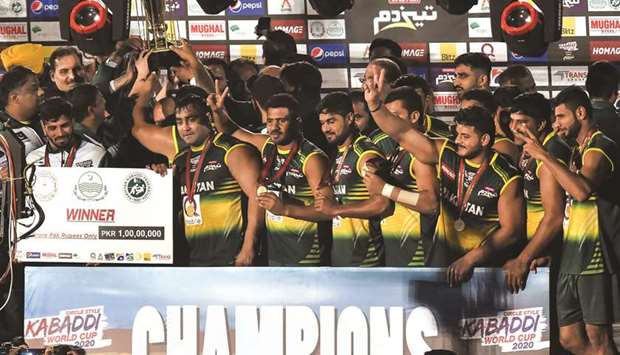 Pakistan players pose with the trophy after beating India in the Kabbadi World Cup 2020 final in Lahore yesterday. (AFP)