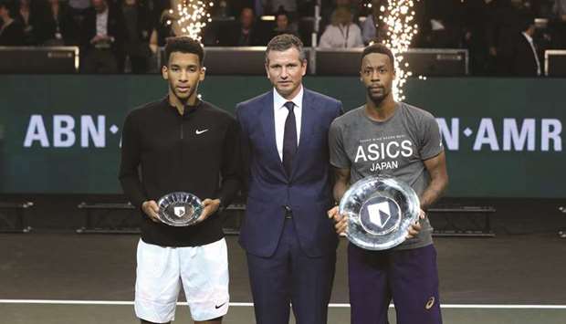 Franceu2019s Gael Monfils (right) holds his plate as he celebrates winning the final alongside Canadau2019s Felix Auger-Aliassime (left) who was runner-up in the ABN AMRO World Tennis Tournament in Rotterdam, Netherlands, yesterday. (Reuters)