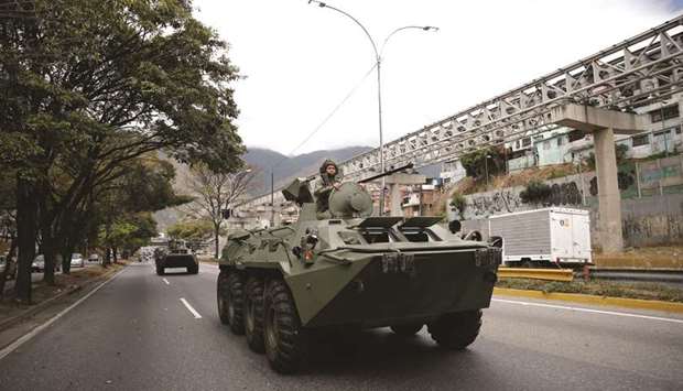 A soldier is seen on an armoured vehicle driven along a highway during a military exercises in Caracas, Venezuela.