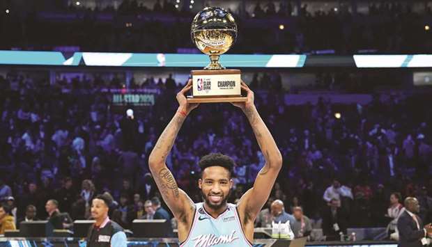 Miami Heat player Derrick Jones Jr holds the trophy after winning the slam dunk contest during NBA All Star on Saturday Night at United Center. PICTURE: USA TODAY Sports