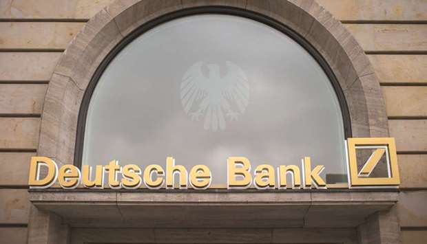 A sign sits above the entrance to a Deutsche Bank branch in Frankfurt.
