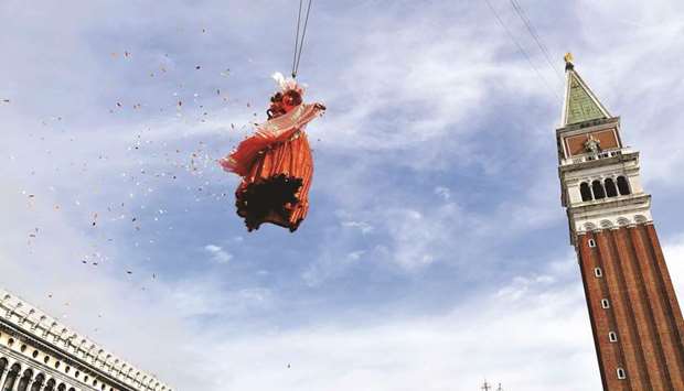 The u2018Angelu2019 of the new Carnival soars near the Bell Tower on St Marku2019s Square in Venice.