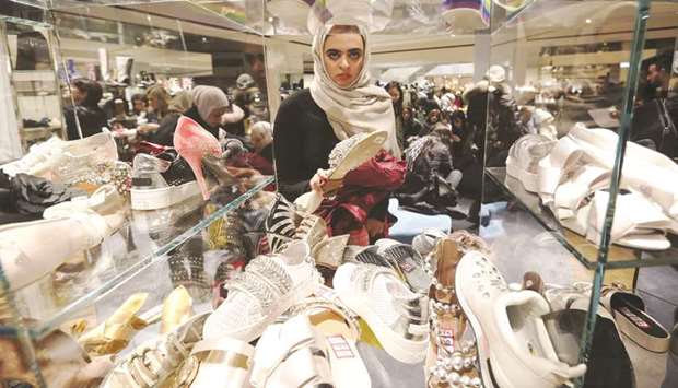 A shopper browses shoes at the Selfridges department store in central London (file).