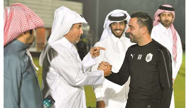 His Highness Sheikh Mohamed bin Khalifa al-Thani speaks to Al Sadd head coach Xavi Hernandez during a practice session in Doha yesterday.