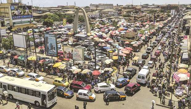 Heavy traffic and umbrellas dominate the skyline of Makola market as people move about buying and selling in Accra, Ghana.