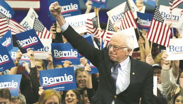 Democratic presidential hopeful Vermont Senator Bernie Sanders waves to supporters at the SNHU Field House in Manchester
