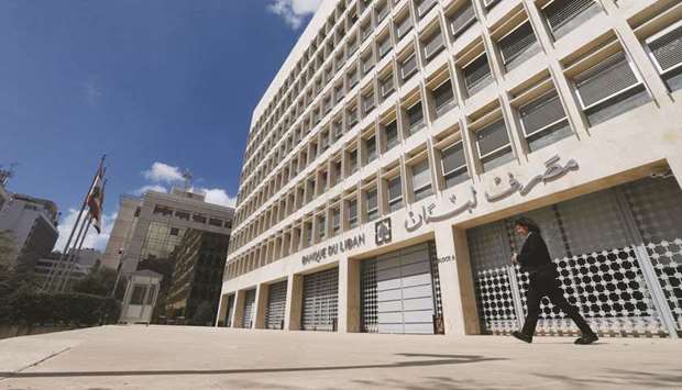 A woman walks outside of Lebanonu2019s central bank building in Beirut (file).
