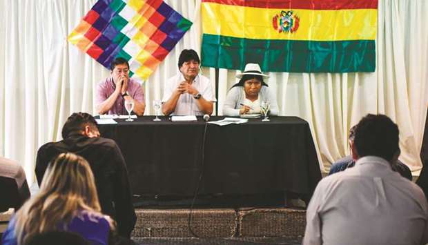 Former president, Evo Morales (centre), speaks next to Bolivian presidential candidate for the Movement for Socialism (MAS) party, Luis Arce (left), and MAS international relations secretary, Juanita Ancieta, during a private meeting with members of their party, in Buenos Aires.