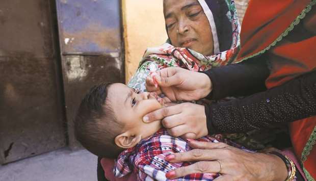 A boy receives polio vaccine drops during an anti-polio campaign in Peshawar.