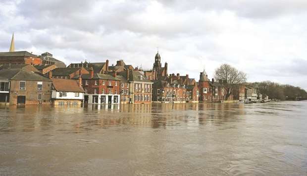 Floodwater rises up the front of buildings alongside the River Ouse in central York after the river burst its banks yesterday.