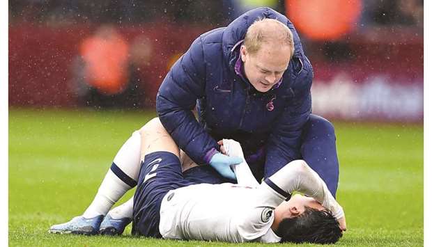 Tottenham Hotspuru2019s South Korean striker Son Heung-Min lies injured on the pitch during the English Premier League match against Aston Villa at Villa Park in Birmingham on February 16, 2020. (AFP)