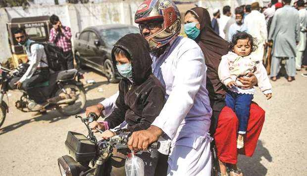 A family arrives at a hospital in Karachi following a gas leak in a coastal residential area of the port city.
