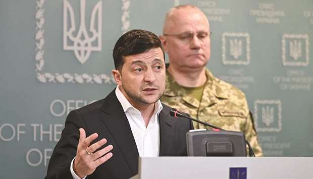 Zelenskiy, flanked by military commander Ruslan Khomchak, speaks at a briefing in Kyiv following an outbreak of violence with pro-Russian separatists on the frontline.
