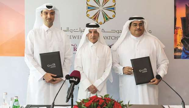 QNBu2019s Yousef Ali Darwish and QNTCu2019s Ahmed al-Obaidly are seen in the presence of QNTC Secretary-General and Qatar Airways Group chief executive HE Akbar al-Baker at the agreement signing ceremony.