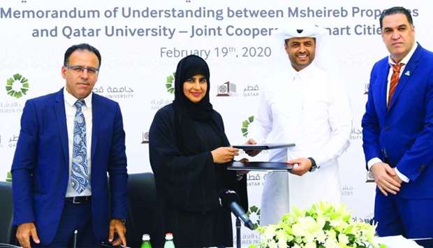 Mohamed Essa al-Boainain and Professor Mariam Ali al-Maadeed shaking hands after signing the MoU in the presence of (from left) QU pre-awards manager Dr Abdelaziz Bouras and Otman Aghmou, senior manager - ICT Commercial. PICTURE: Jayan Orma