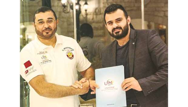 Qatari rally driver Khalid al-Mohannadi (left) with Universal Sportsu2019 marketing director Zaid Yaaroub after signing a sponsorship agreement.