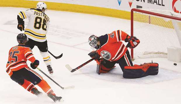 Boston Bruins forward David Pastrnak scores the overtime winning goal against Edmonton Oilers goaltender Mike Smith at Rogers Place in Edmonton. PICTURE: USA TODAY Sports