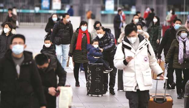 Passengers wearing facemasks arrive from different provinces at the Beijing Railway Station. Several Chinese provinces  accounting for about 90% of copper smelting, 60% of steel production, 65% of oil refining and 40% of coal output have told companies to delay the restart of operations until at least February 10.