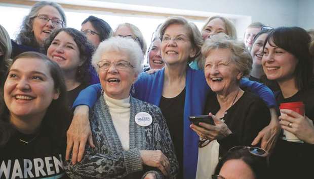 Democratic 2020 presidential candidate and US Senator Elizabeth Warren (D-MA) poses with supporters at a campaign event yesterday in Urbandale, Iowa.