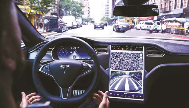 A driver rides hands-free in a Tesla Motors Model S vehicle equipped with Autopilot hardware and software in New York (file).