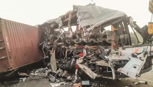 The wreckage of a bus hit by a truck, at Tirupur in Tamil Nadu, lies by the highway.