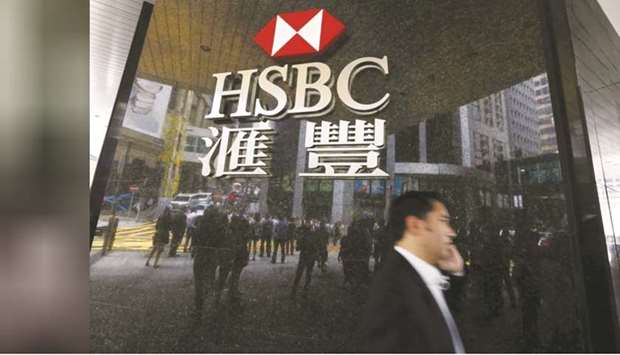 A man walks past an HSBC bank branch at the financial central district in Hong Kong. Lenders from HSBC to the three biggest banks in Singapore have warned that the coronavirus and related economic slowdown will likely force them to set aside more money for soured loans this year.