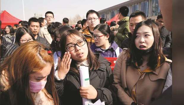 Job seekers listen to a recruiter at a job fair at Liberation Square in  Shijiazhuang, Hebei province (file). Graduates in China are worrying less about catching the virus than the impact it will have on their careers as company-organised recruiting events on campuses across China are pushed back or cancelled amid nationwide bans on public gatherings to avoid the spread of disease.