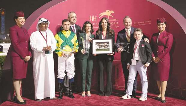 Irelandu2019s ambassador to Qatar Aidan Cronin (fourth from left) and Qatar Racing and Equestrian Clubu2019s deputy chief steward Abdulla al-Kubaisi (second from left) pose with the winners of the Irish Thoroughbred Marketing Cup (QA Group 2) after Frederic Rossi-trained Stunning Spirit won the mile-long feature at Al Rayyan Park yesterday. PICTURES: Juhaim