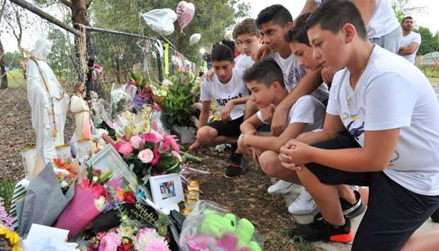Schoolmates of one of the boys killed gather to pay their respects at a makeshift memorial at the site of an accident which killed four children the day before, in the Oatlands suburbs of Sydney