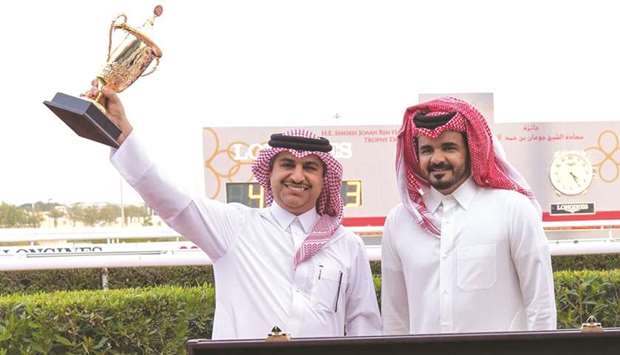QOC President HE Sheikh Joaan bin Hamad al-Thani with The Blue Eye trainer Jassim Mohamed Ghazali (left) after the eight-year-old won the HE Sheikh Joaan Bin Hamad Al Thani Trophy for four-year-old and older Thoroughbreds at Al Rayyan Park Saturday.