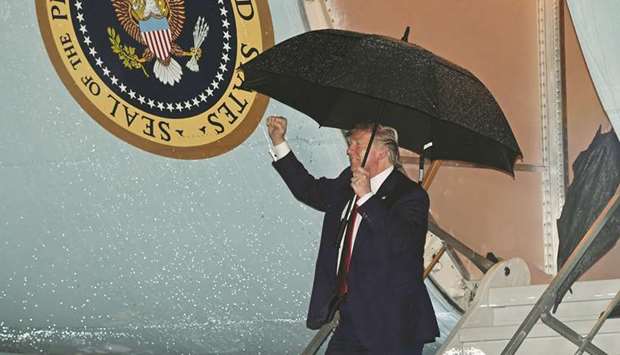 President Donald Trump steps off Air Force One upon arrival at Palm Beach International Airport in West Palm Beach, Florida on Friday night.