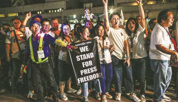 Supporters and employees of ABS-CBN, the countryu2019s largest broadcast network, shout slogans as they join a protest in front of the broadcasteru2019s building in Manila, yesterday.