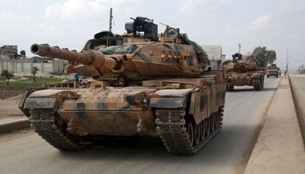 A convoy of Turkish M-60T tanks patrols in the town of Atareb in the rebel-held western countryside of Syria's Aleppo province on February 19