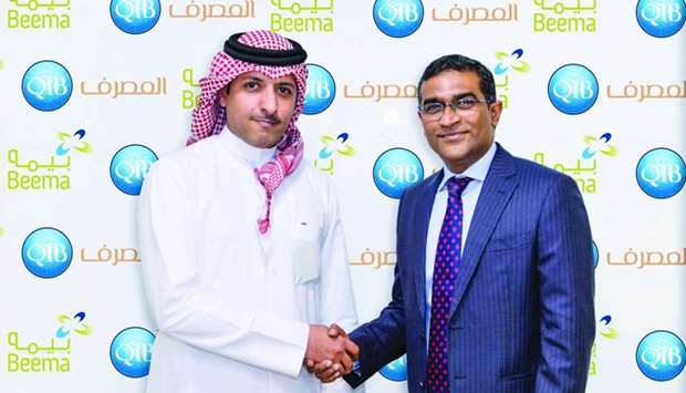 D Anand, QIBu2019s general manager u2013 Personal Banking Group, and Nasser al-Misnad, CEO, Damaan Islamic Insurance Company (Beema), shaking hands on the occasion of both organisation's partnership to provide Takaful plans for QIB customers on its mobile App.