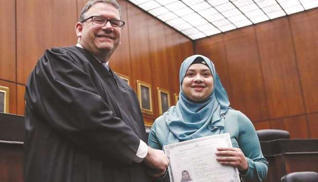 Lila Mubarak receives a certificate of naturalisation during a ceremony in Chicago.