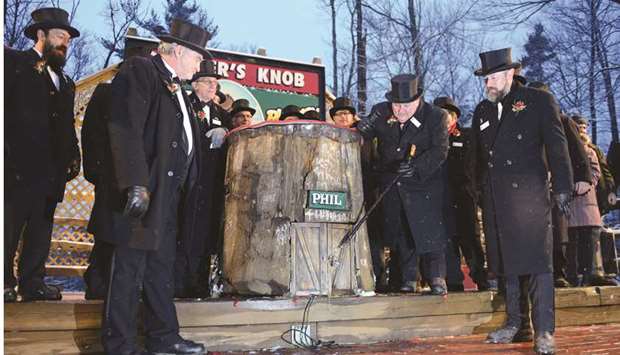 Groundhog Club president Bill Deeley knocks on Philu2019s burrow door to wake him on the 134th Groundhog Day at Gobblers Knob in Punxsutawney, Pennsylvania.