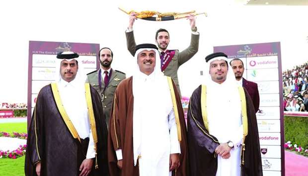 His Highness the Amir Sheikh Tamim bin Hamad al-Thani poses with the winner of the His Highness The Amir's Sword Showjumping Championship, Salman Mohamed al-Emadi (top centre), runner-up Mubarak Yousuf al-Rumaihi (top left) and third-placed Faleh Suwead al-Ajami yesterday. Also seen are Vodafone Qataru2019s Chief Executive Officer Sheikh Hamad bin Abdullah al-Thani (front right), and Asian and Qatar Equestrian Federation President Hamad Abdurahman al-Attiyah (front left).