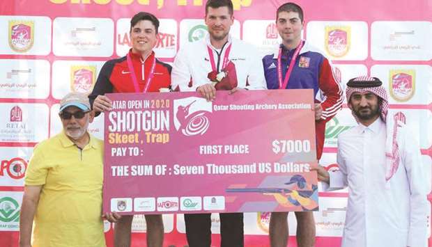 Menu2019s skeet event winner Czech Republicu2019s Jakub Tomecek (centre) poses with runner-up Ben Llewellin (second left), third placed Milos Slavicek (second right) and officials at the Qatar Open Shotgun championship at the Losail Shooting Range yesterday.