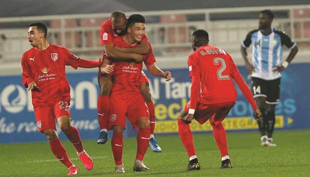 Al Duhailu2019s Han Kwang-Song (second right) celebrates with teammates after scoring against Al Wakrah yesterday.