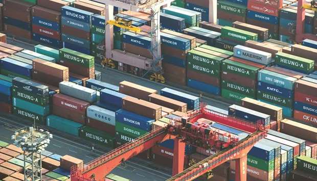 Shipping containers sit stacked among gantry cranes at the Busan Port Terminal (BPT) in South Korea. The countryu2019s daily average shipments fell 9.3% during the first twenty days of February from a year earlier, the customs office said on Friday.