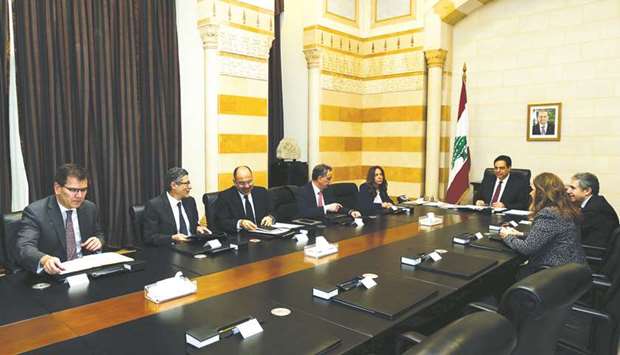Lebanese Prime Minister Hassan Diab and officials meet with a team of IMF experts at the government palace in Beirut on February 20. The IMF delegation arrived in Lebanon to assess the sustainability of government debt that exceeds 150% of economic output.