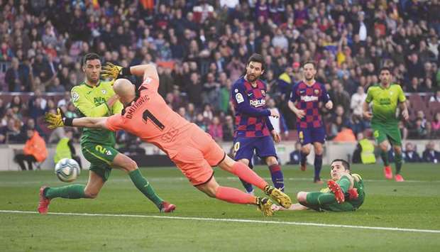 Barcelonau2019s forward Lionel Messi (centre) scores against Eibar during the La Liga at the Camp Nou stadium in Barcelona yesterday. (AFP)