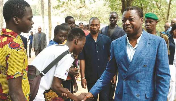 Togolese President Faure Gnassingbe, and candidate of the ruling Union for the Republic (UNIR) party greets people queuing to vote after casting his vote at a polling station in Kara, yesterday.